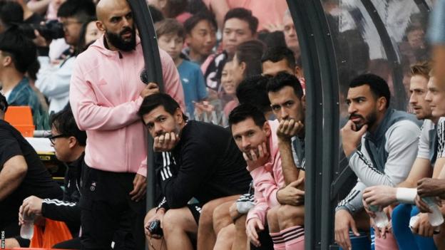 Lionel Messsi sits on the bench during a friendly match in Hong Kong