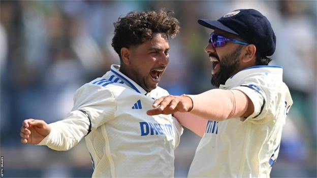 India spinner Kuldeep Yadav (left) celebrates with captain Rohit Sharma (right) after taking a wicket