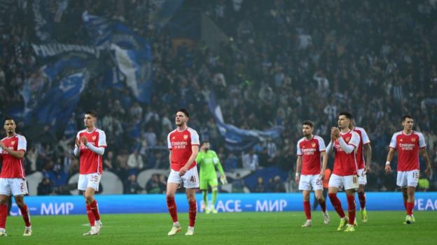 Arsenal fans look deflated as they applaud the travelling fans