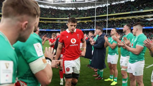 Ireland players clap Wales captain Dafydd Jenkins off the field