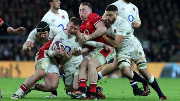 Tommy Reffell tackles an England player