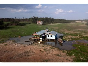 Floating houses in a drought-hit harbor of Cacau Pirêra in Iranduba, Brazil in October.