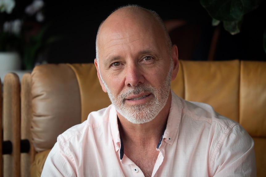 A man wearing a pink shirt.