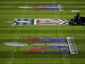 Grounds crew prepare the field outside Allegiant Stadium ahead of the NFL Super Bowl 58 football game, early Saturday, Feb. 3, 2024, in Las Vegas.