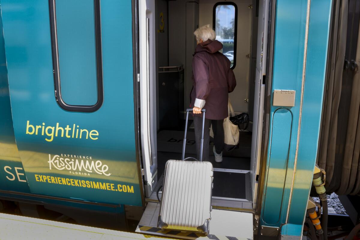 A passenger gets onboard at the Brightline Aventura Station in Aventura