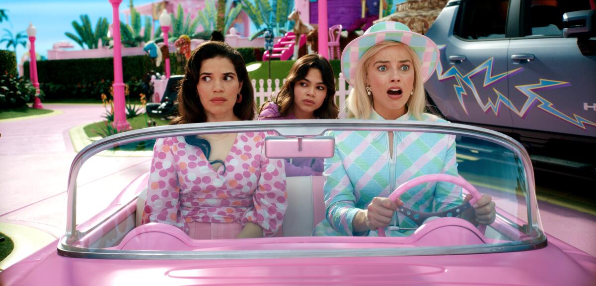 Left to right: America Ferrera as Gloria, Ariana Greenblatt as Sasha and Margot Robbie as Barbie in "Barbie."