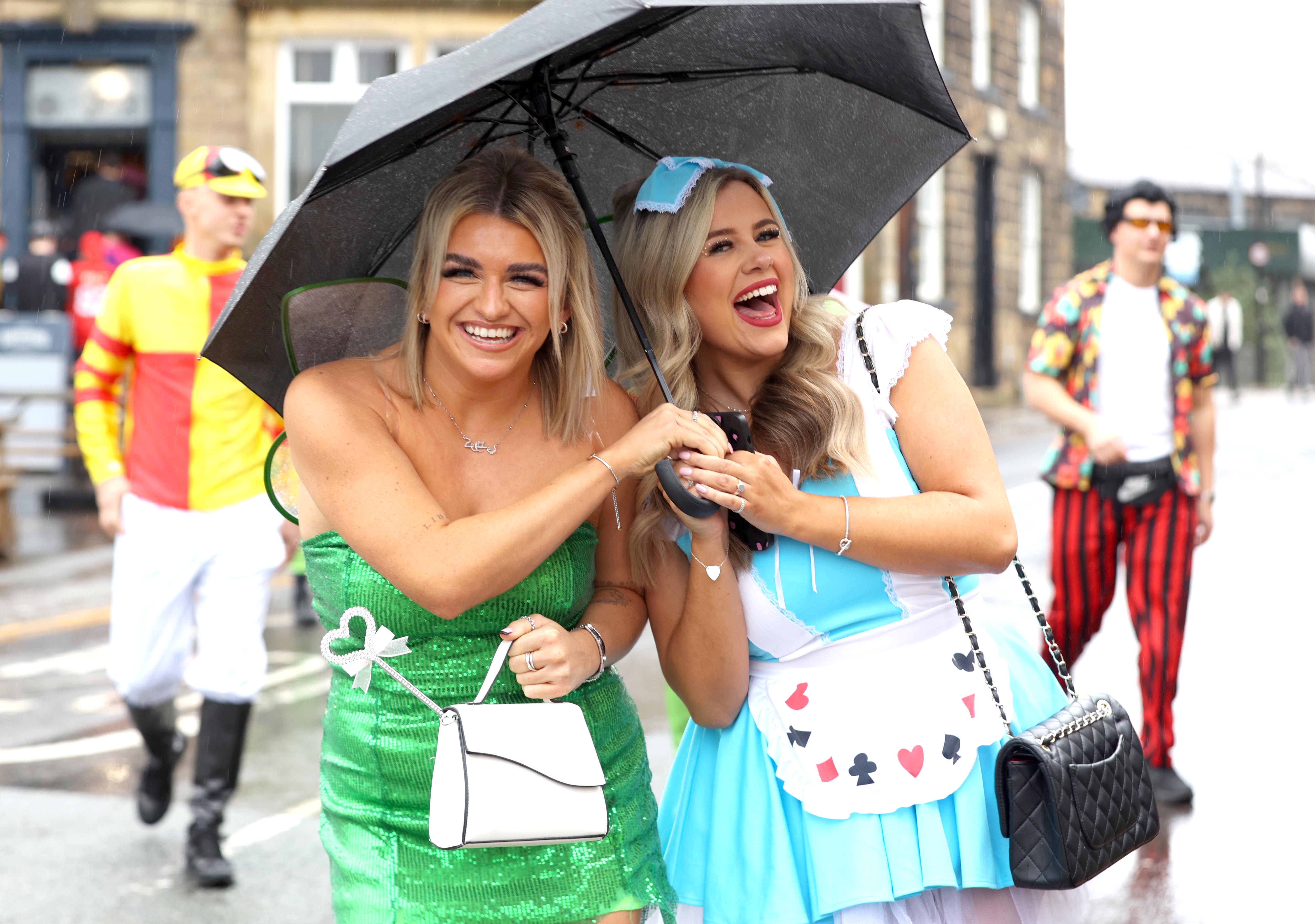 Tinkerbell and Alice in Wonderland were all smiles as they shared an umbrella