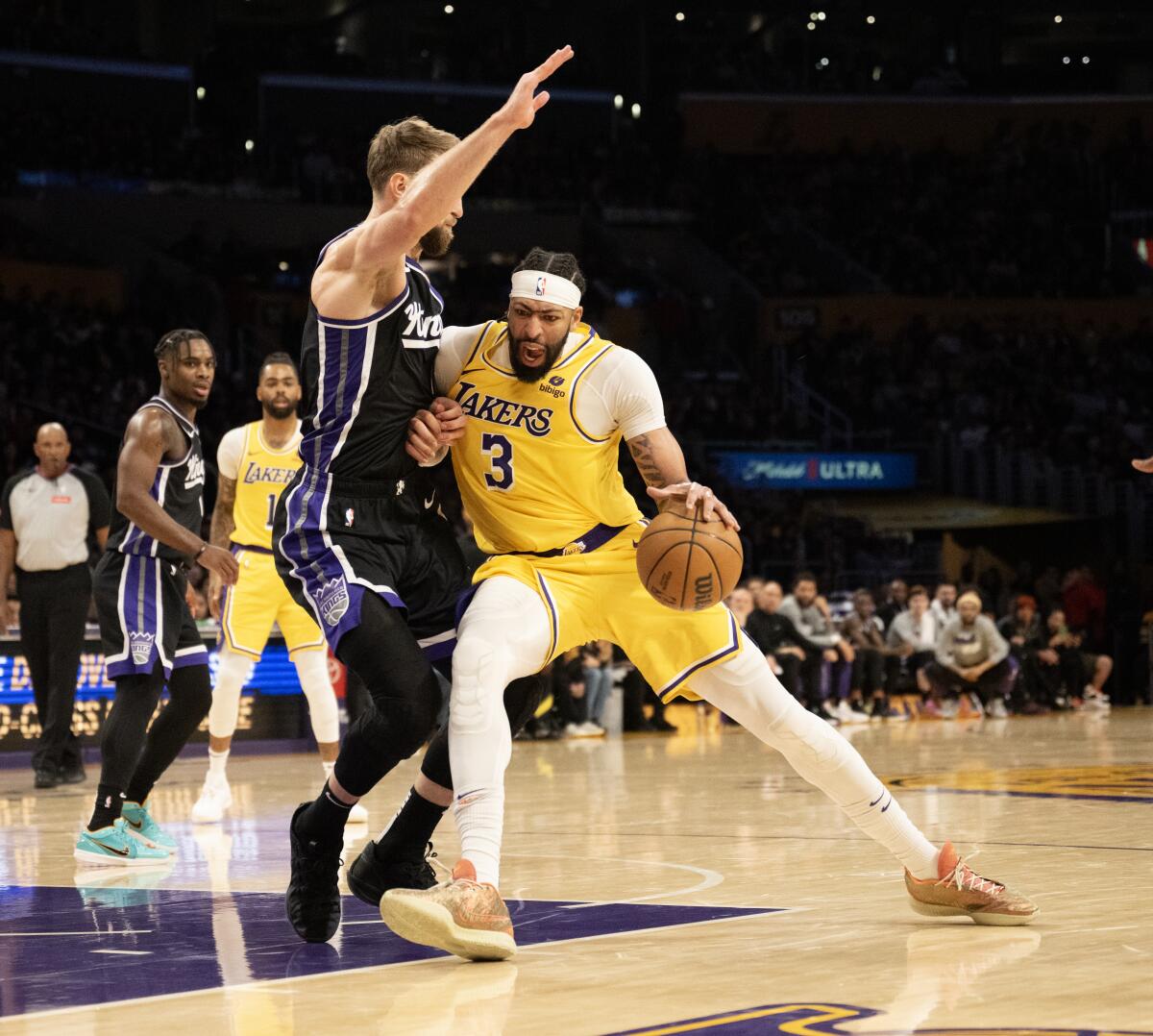 Kings forward Domantas Sabonis plays tight defense on Lakers forward Anthony Davis Wednesday at Crypto.com Arena.