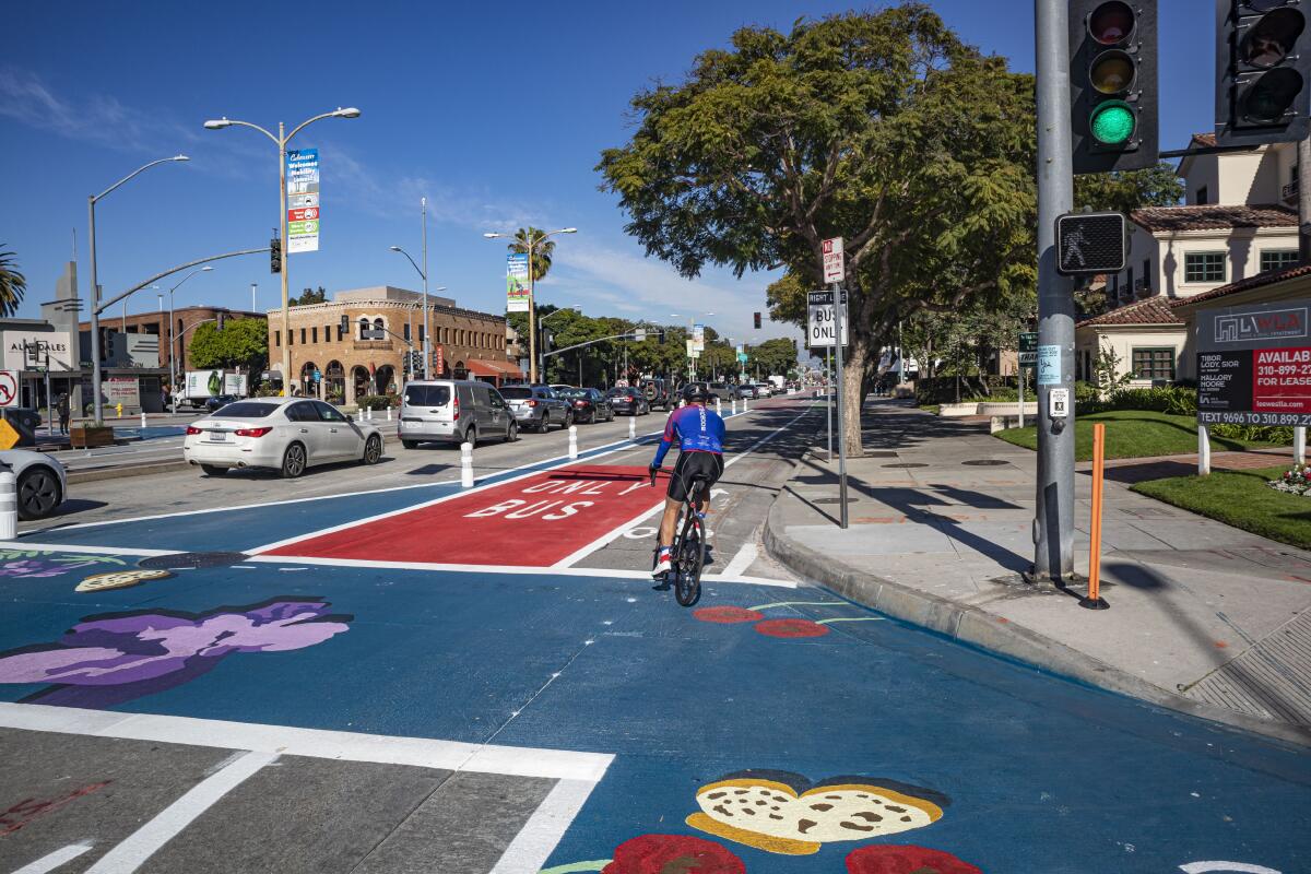 A bicyclist turns at a street intersection.