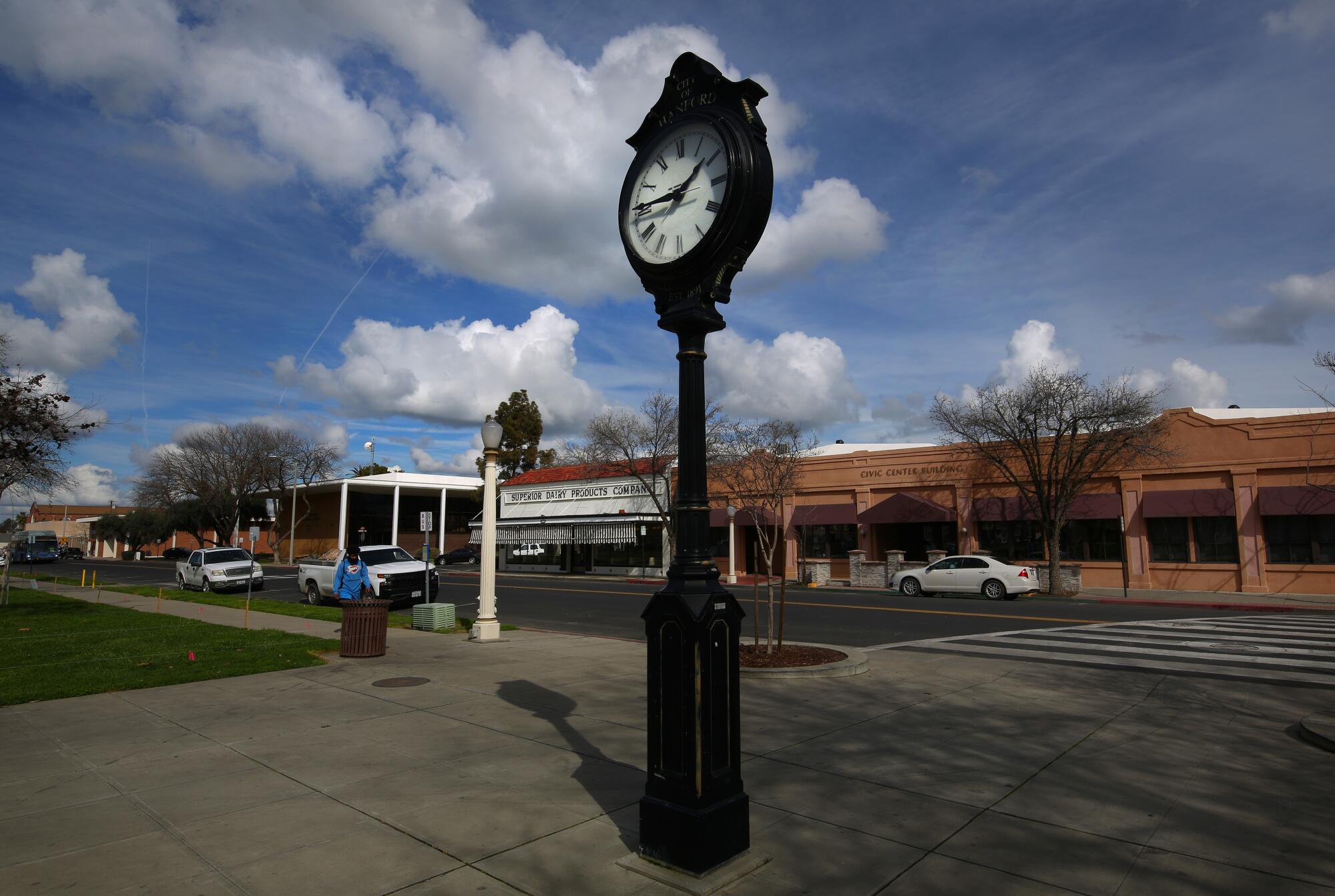 A clock in the foreground and an ice cream parlor in the background