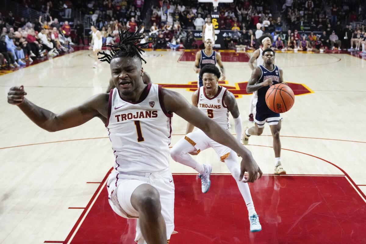 USC guard Isaiah Collier (1) celebrates after scoring on a breakaway dunk against Arizona on Saturday.