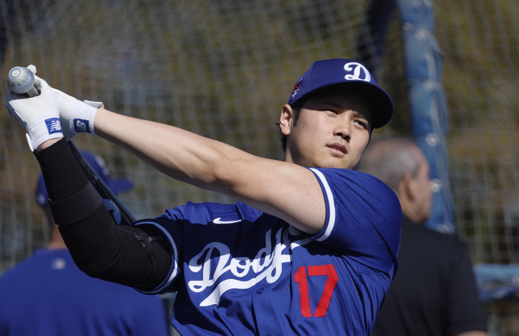 Shohei Ohtani warms up near the batting cage before taking some swings during spring training in February.