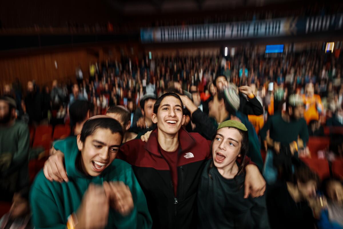 People dancing on the crowded floor of a convention