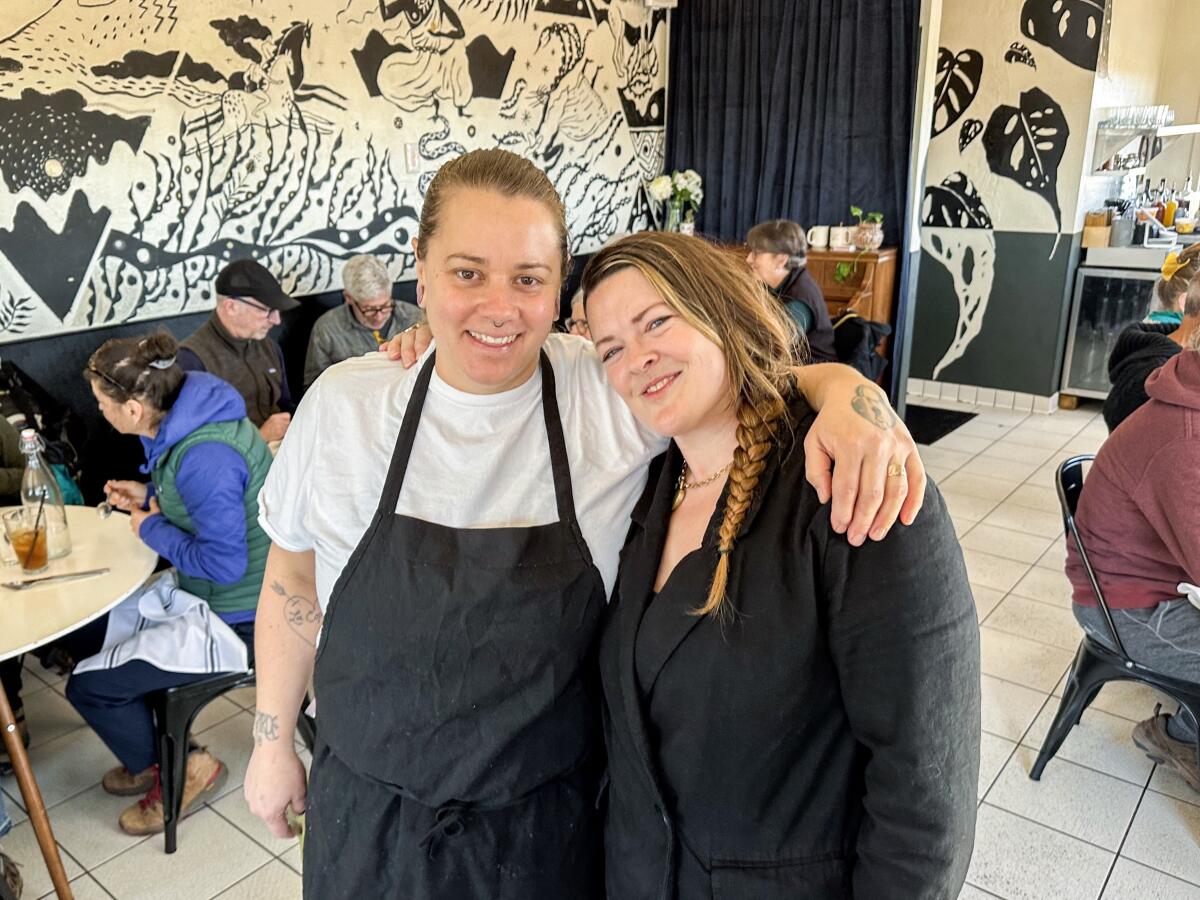 Nikki Hill and Claire Wadsworth stand in the ever-busy dining room of their daytime restaurant La Copine.