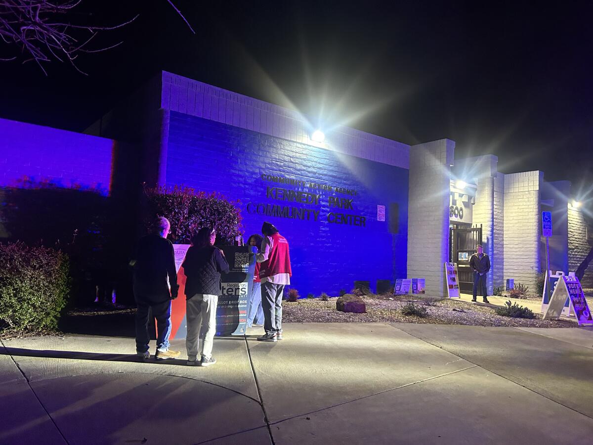 Jim Hicks, far right, stands watch at the Kennedy Park Community Center in Stockton on March 5 