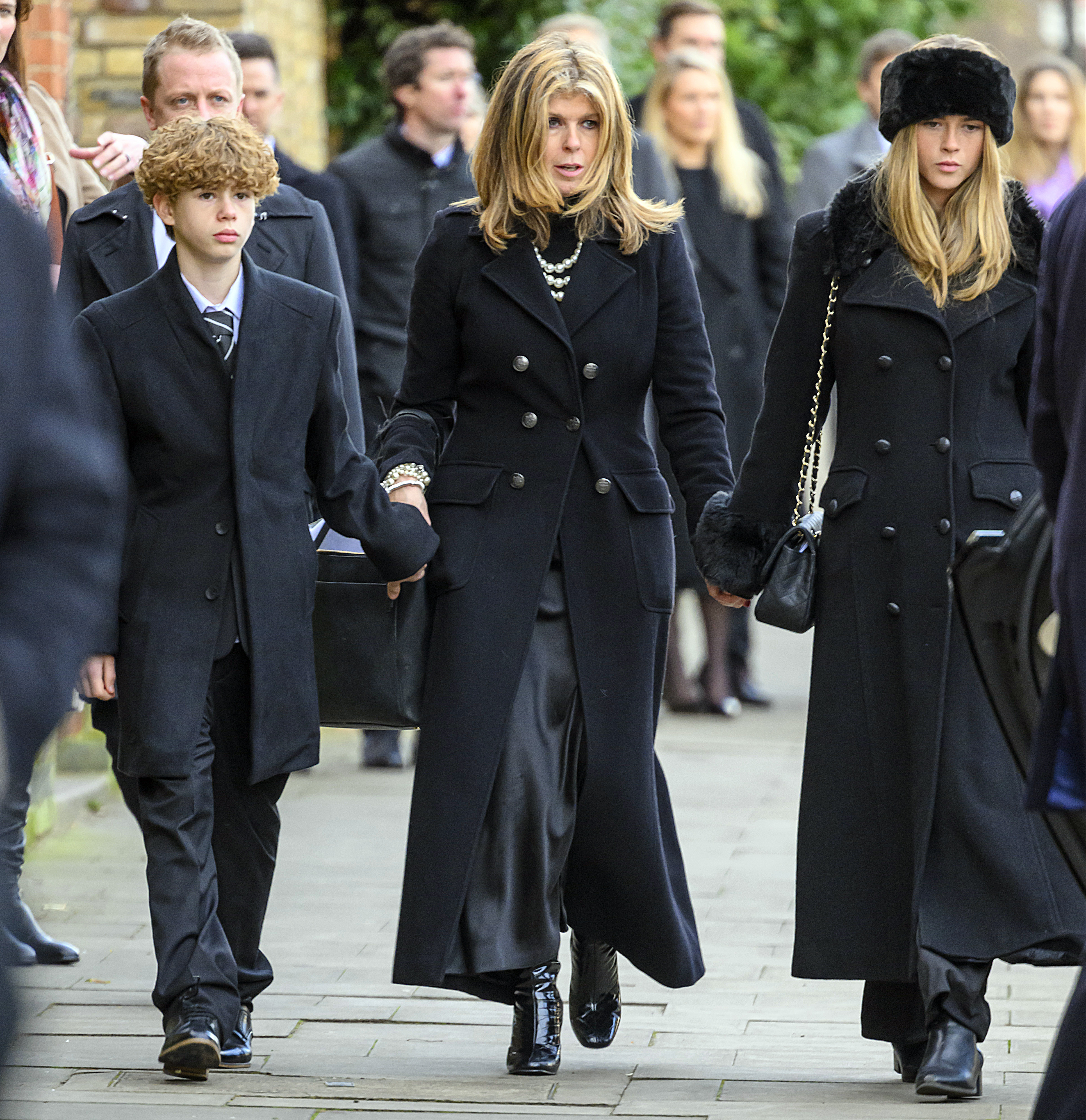 Garraway and the couple's two children at Derek's funeral