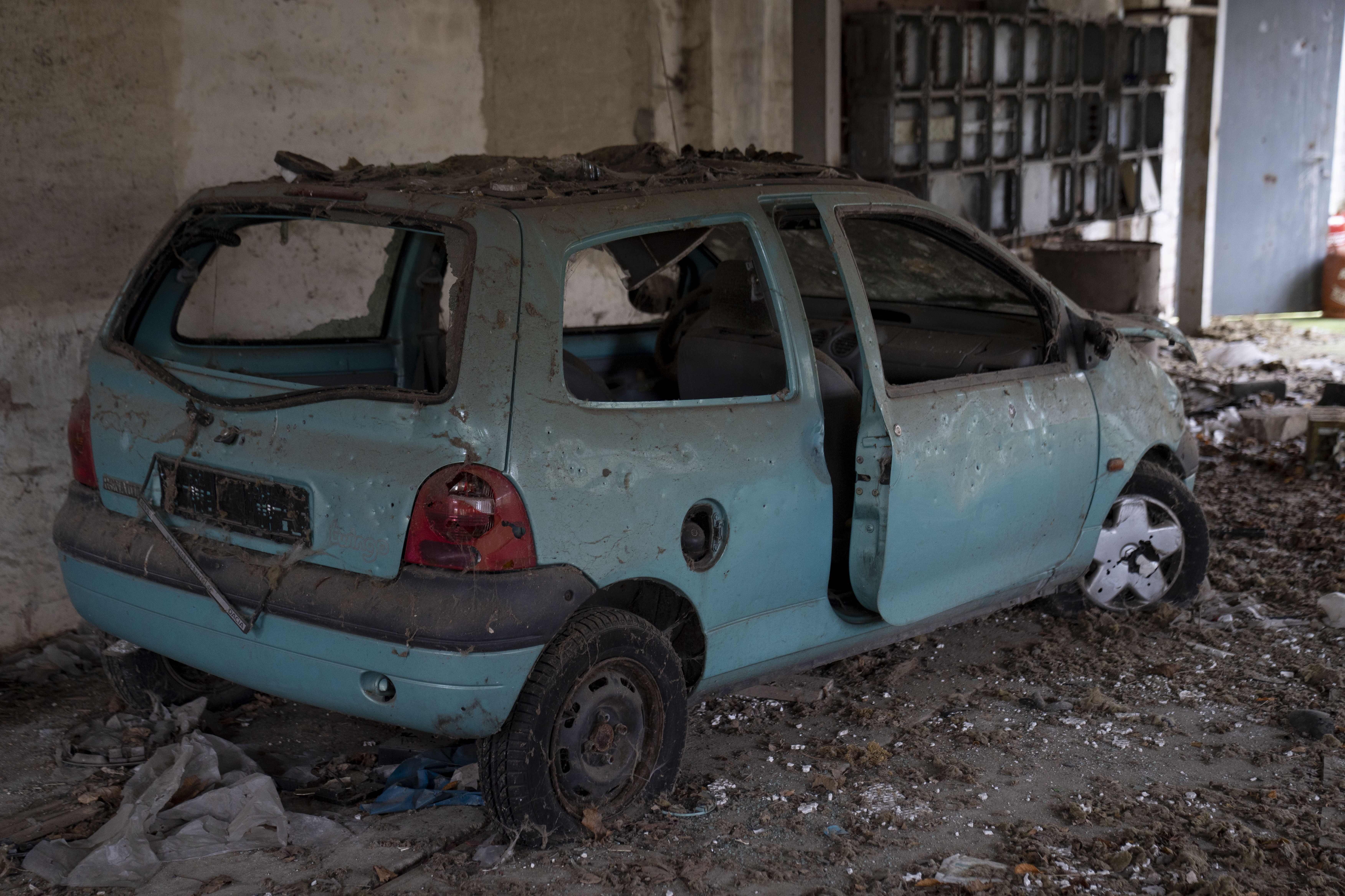 An abandoned car left to rot at the scrapyard