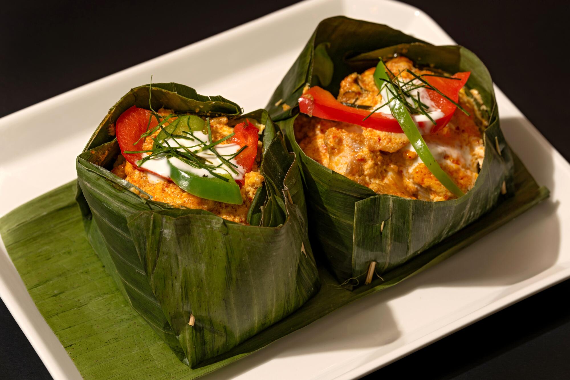 Two banana-leaf bowls filled with ahmok at Sophy's: Cambodia Town Food & Music