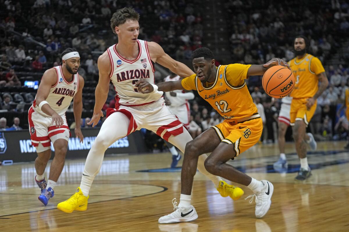 Arizona guard Pelle Larsson (3) guards Long Beach State guard Jadon Jones (12) as he drives up the court 