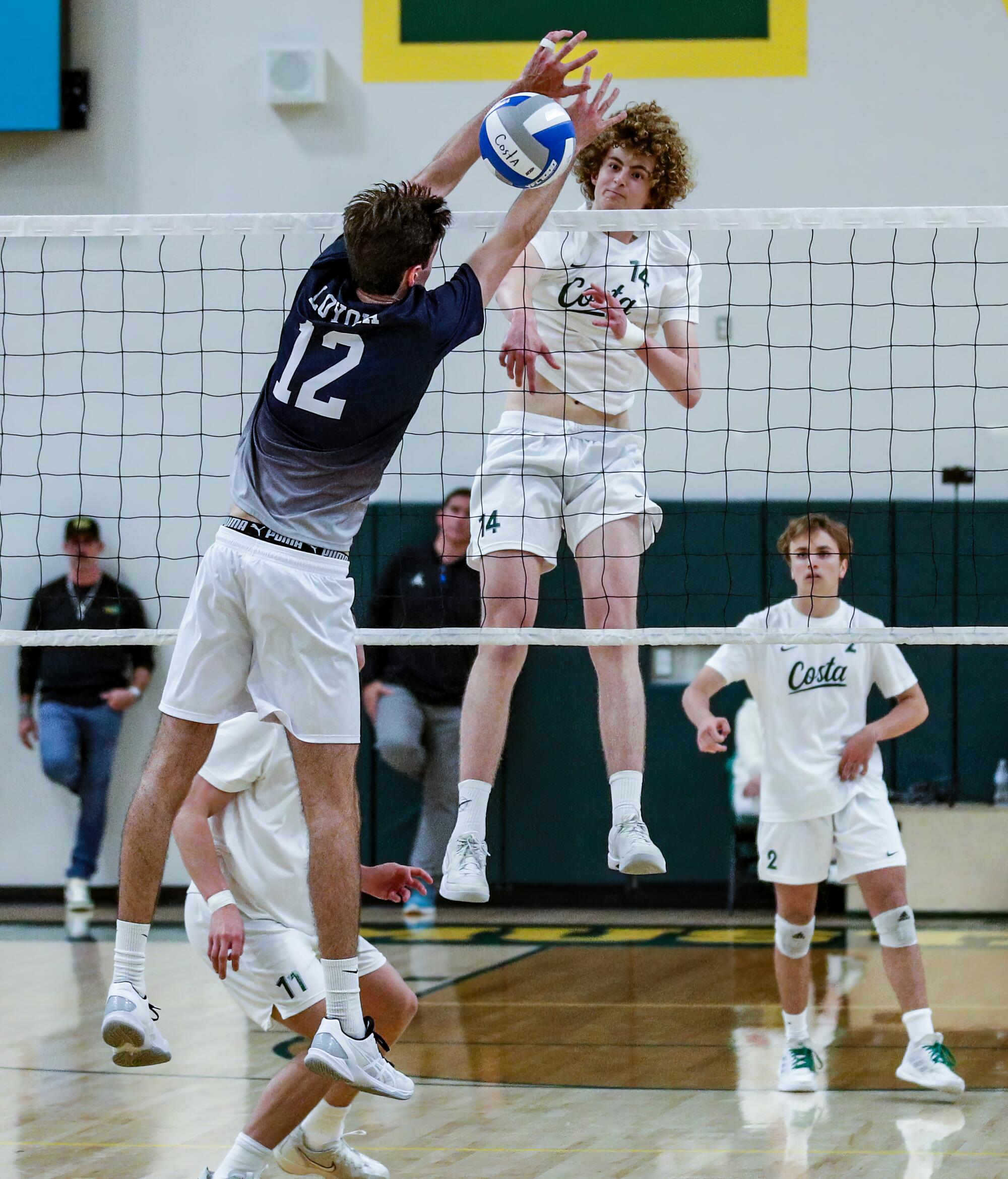 Wyatt Davis of Mira Costa delivers a kill against Loyola's Sean Kelly.