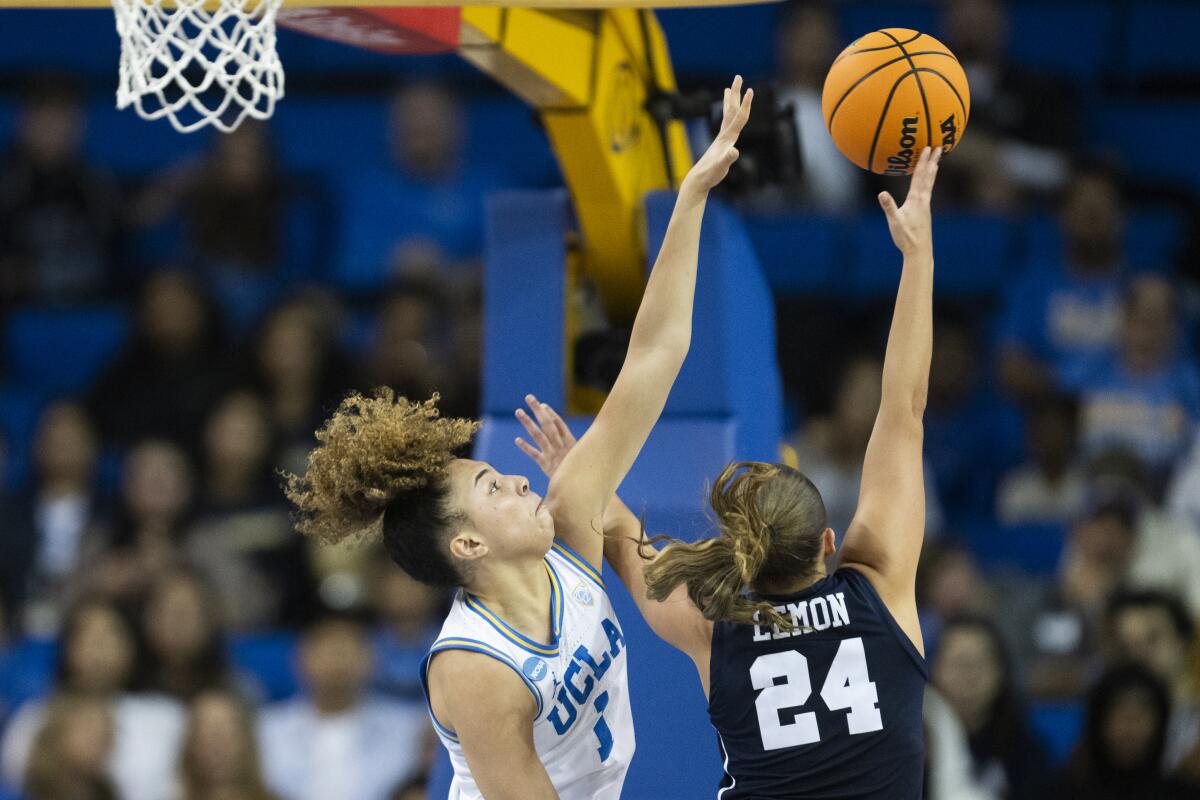 UCLA guard Kiki Rice tries to block a shot by California Baptist guard Khloe Lemon during the first half.