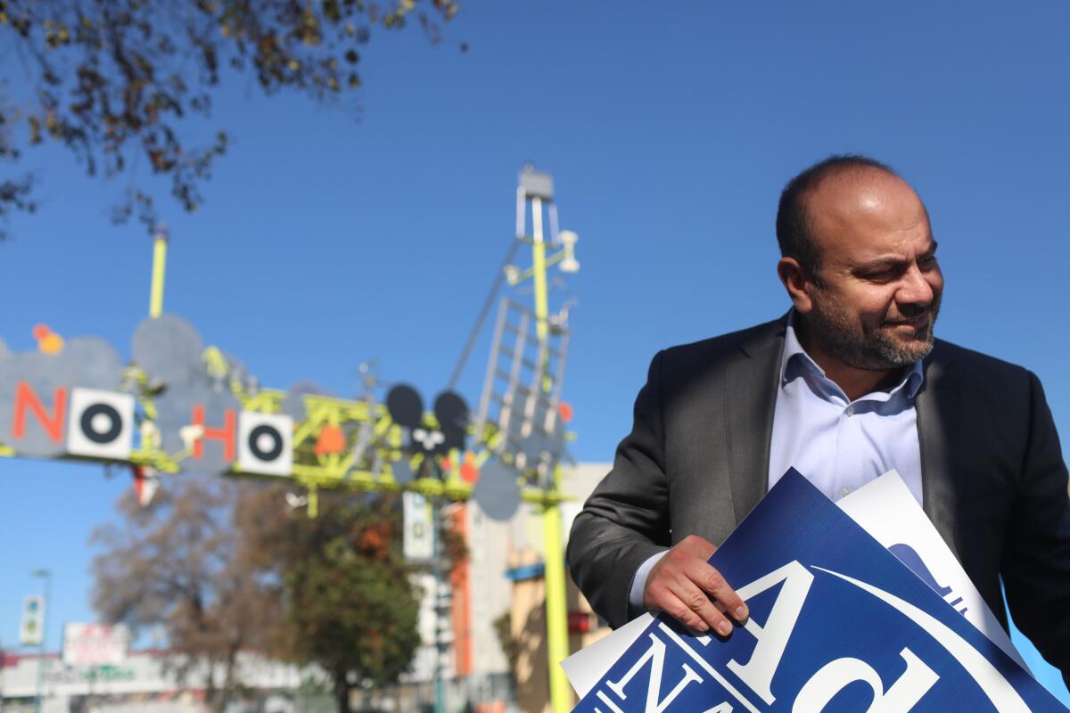 Los Angeles City Council candidate Adrin Nazarian grabs campaign signs in North Hollywood.