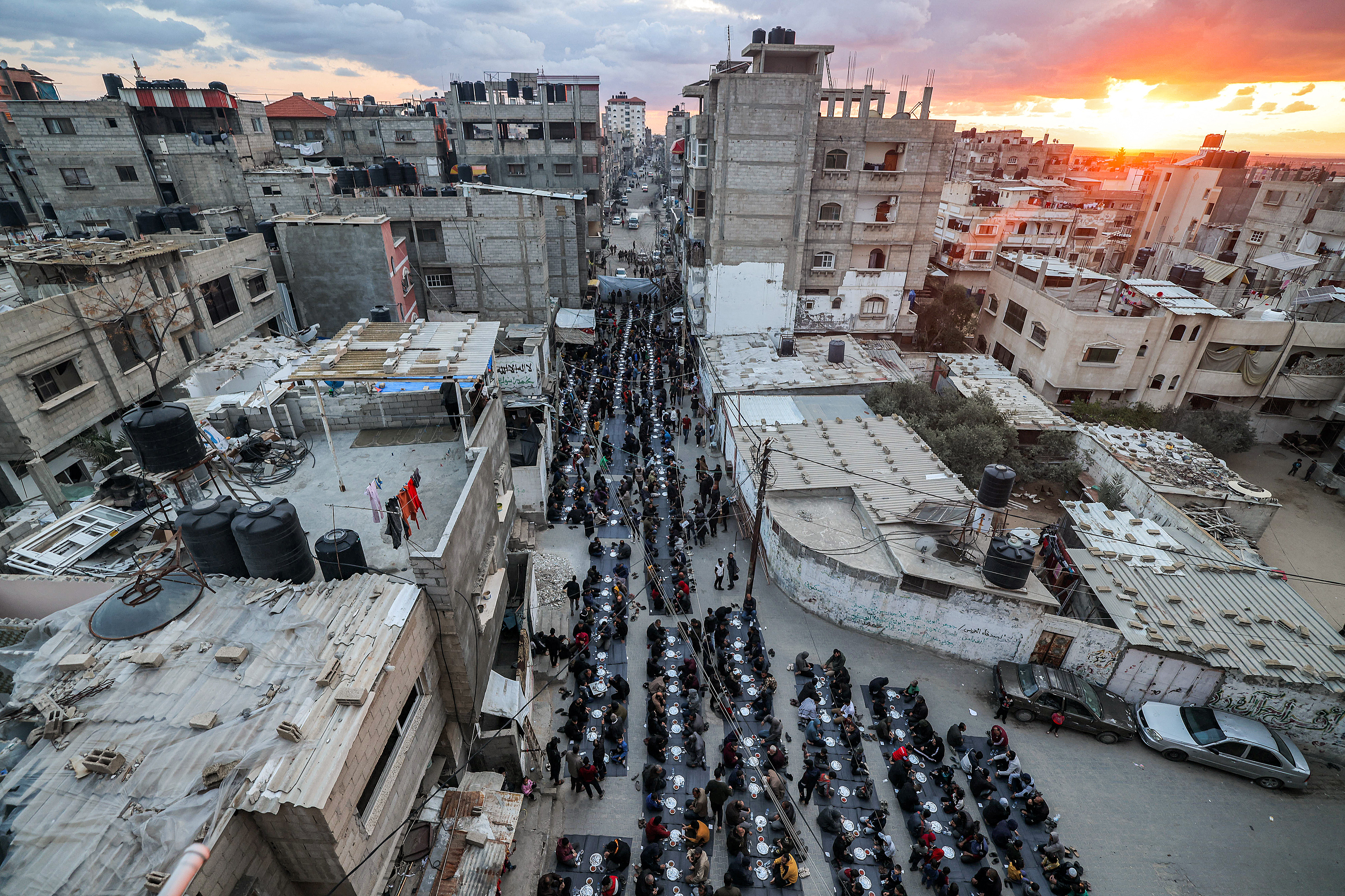 Gazans in a refugee camp in Rafah coming together to break their fast during Ramadan