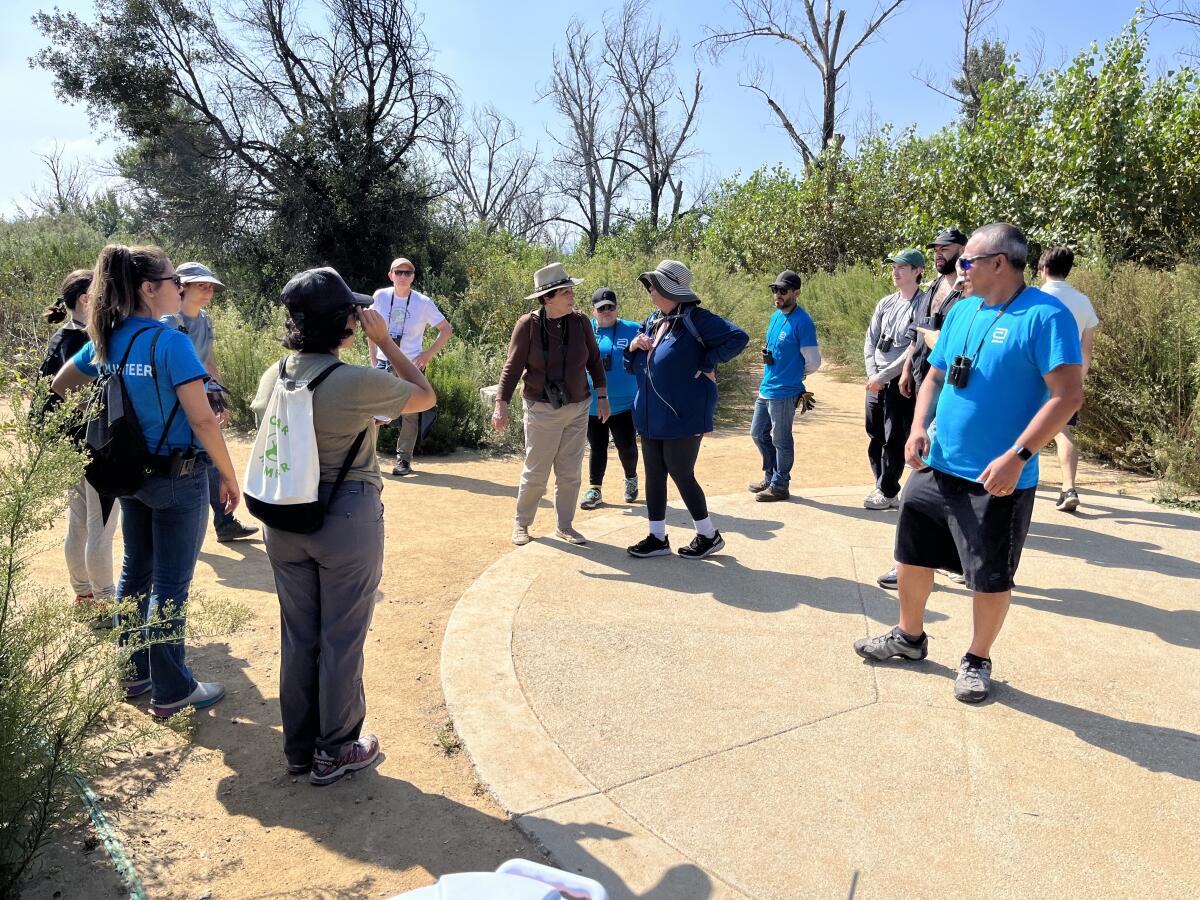 A group of folks gather around a dusty path Sepulveda Basin Wildlife Reserve