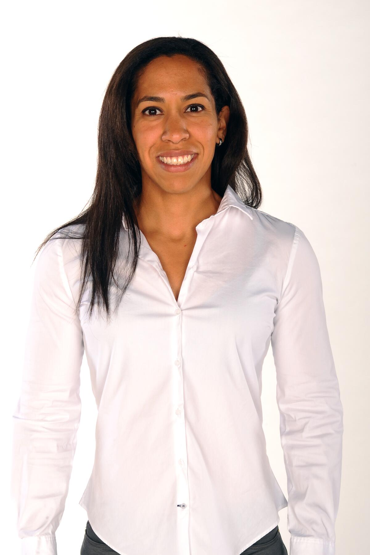 Kelly Dormandy smiles while wearing a white button up shirt.