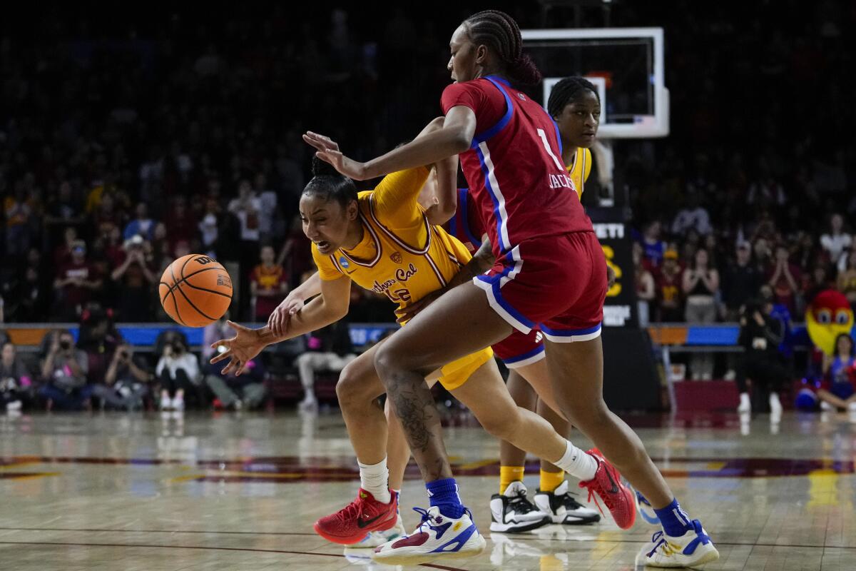 USC guard JuJu Watkins is fouled by Kansas guard Holly Kersgieter.