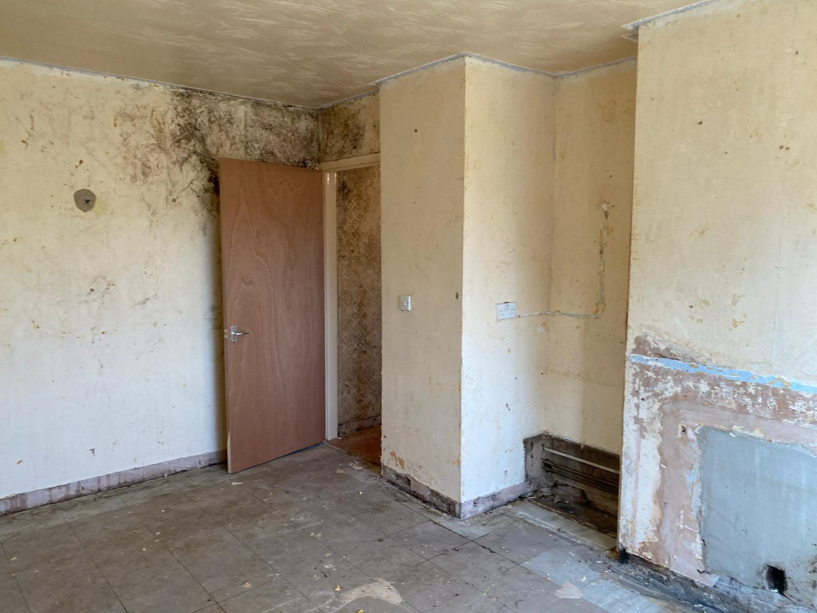 The wallpaper was peeled off and the ceiling covered in yellow paint