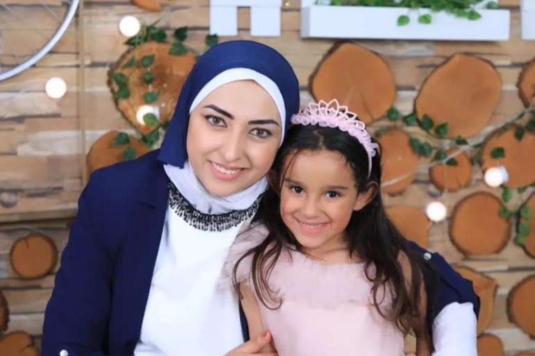 Alaa with her arm around Orchid who is wearing pink with a pink tiara