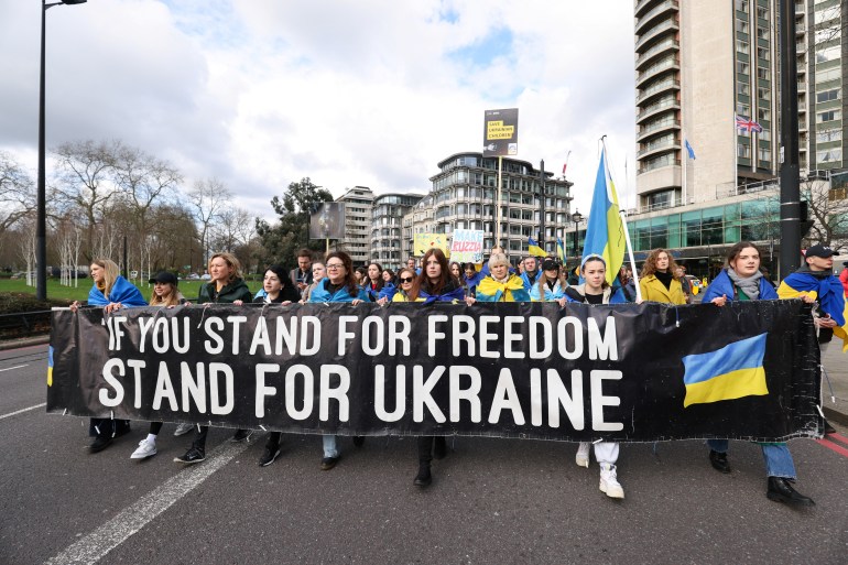 People hold a banner as they demonstrate on the two-year anniversary of Russia's invasion of Ukraine, in London, Britain, February 24