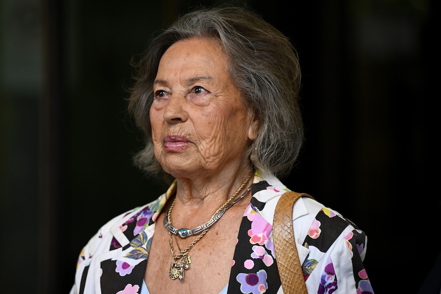 A woman with grey hair and a colourful jacket