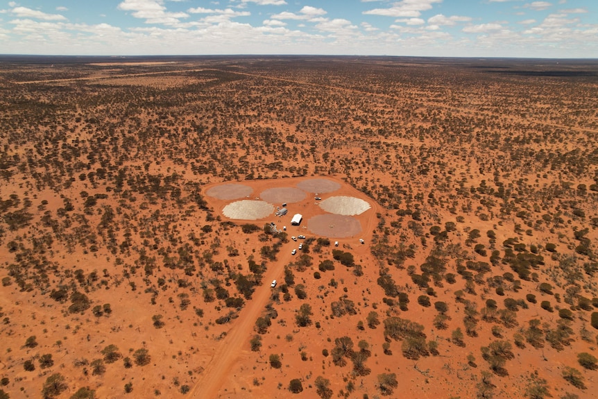 An aerial drone shot of a facility being built in the WA outback, with lots of red dirt surrounding. 