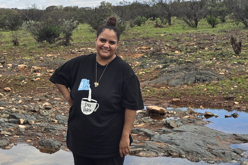 She stands on a flooded landscape