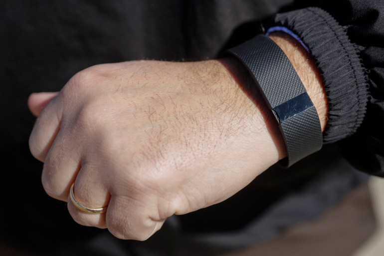 FILE - In this Monday, Feb. 29, 2016, file photo, Brett Broviak, a manager of respiratory and sleep services at IU Health North Hospital, shows off his Fitbit fitness tracker for the camera on the hospital's campus in Carmel, Ind. Fitbit reports financial results Wednesday, May 4, 2016. (AP Photo/AJ Mast, File)