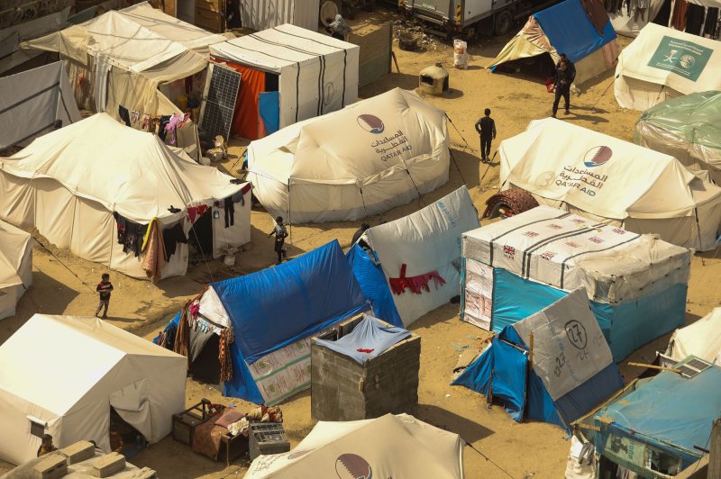 Displaced Palestinians live in makeshift tents in the Rafah refugee camp in southern Gaza. An airdrop from an unknown foreign country killed five children and injured several others at the Al Shati camp west of Gaza City. Humanitarian workers have criticized air drops as being dangerous and not sufficient to meet the needs of people in Gaza. Photo by Ismael Mohamad/UPI