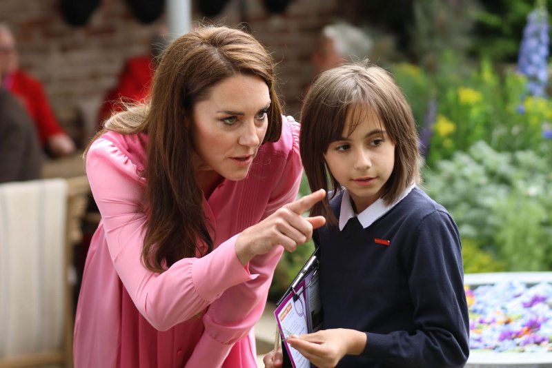 Catherine, Princess of Wales said in a Friday video announcement that she has cancer and is the early stages of treatment. She said it came as a shock following successful abdominal surgery. She's pictured here with a child during her visit to a garden at the 2023 Chelsea Flower Show in London May 22, 2023. File Photo by Hugo Philpott/UPI