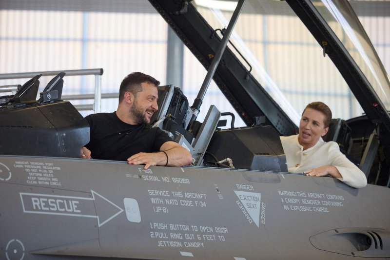 Ukrainian President Volodymyr Zelenskyy meets with Danish Prime Minister Mette Frederiksen at Skrydstrup Airbase, in Vojens, Denmark, on Sunday, August 20, 2023. The two nations agreed on transferring 19 F-16 fighter jets from Denmark to Ukraine, with training missions having already begun. On Wednesday, Denmark announced it plans to conscript women into its military. File Photo via Ukrainian Presidential Press Office/UPI