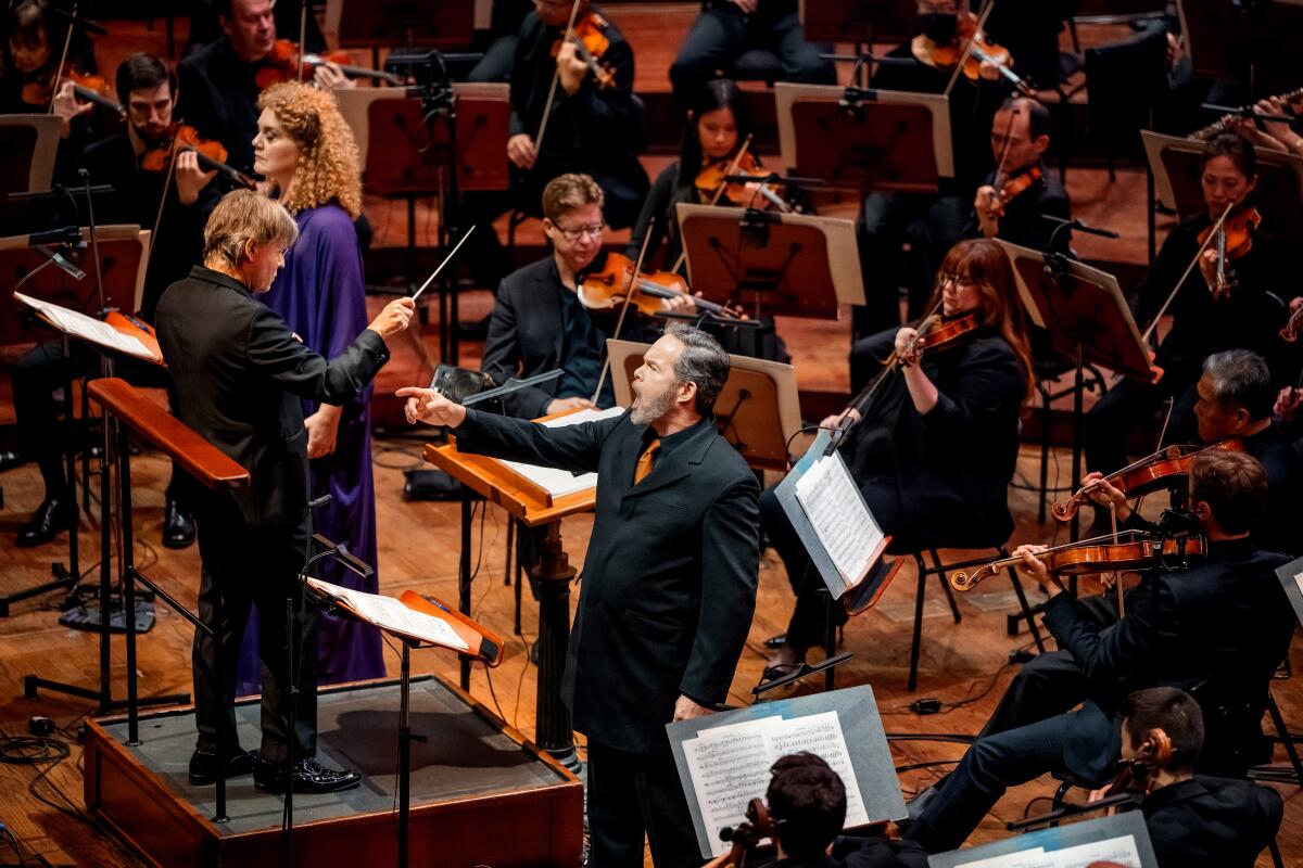 Esa-Pekka Salonen conducts as soloists sing.