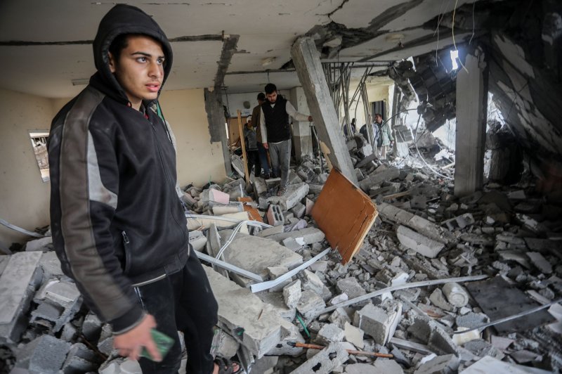 Palestinians search the rubble of a house that was hit by Israeli bombardment late the previous night in Rafah in the southern Gaza Strip, on Tuesday, March 19, 2024.Photo by Ismael Mohamad/UPI.