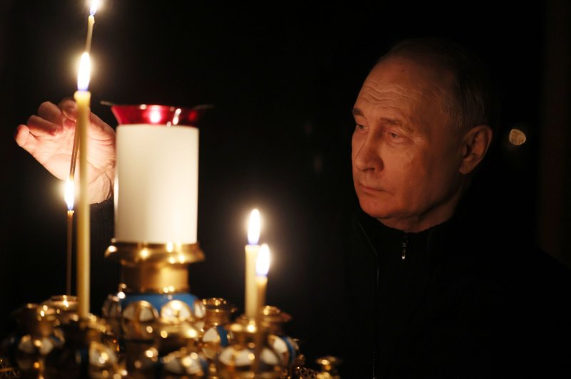 Russian President Vladimir Putin lights a candle to commemorate the victims of a terrorist attack on the Crocus City Hall concert venue on a day of national mourning in Moscow, Russia, on Sunday. Photo by Mikhail Metzel/SPUTNIK/KREMLIN POOL/EPA-EFE