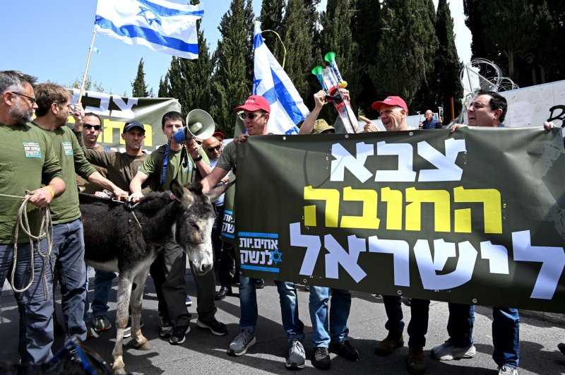 Israeli army reserve activists protest against military exemption for the ultra-Orthodox Haredi outside Prime Minister Benjamin Netanyahu's office. The High Court on Thursday ordered a freeze to government funding to Haredi religious schools, which have served as a legal framework exempting students from military service. Photo by Debbie Hill/ UPI