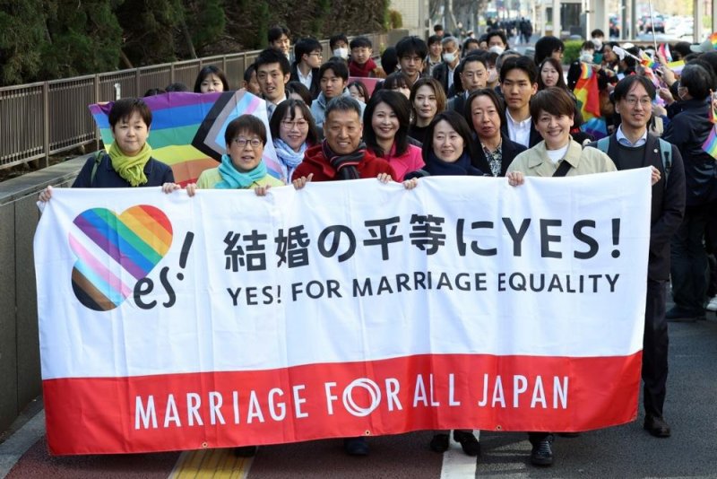 Plaintiffs hold a banner before the ruling on same-sex marriage at the Tokyo District Court in Tokyo on Thursday. Photo by Jiji Press/EPA-EFE