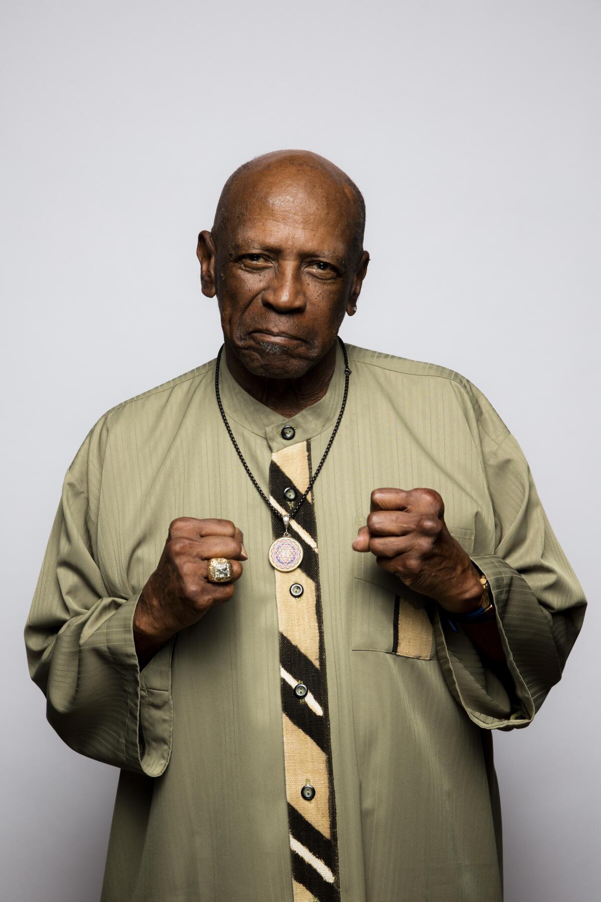 A portrait of Louis Gossett Jr. wearing a medallion.