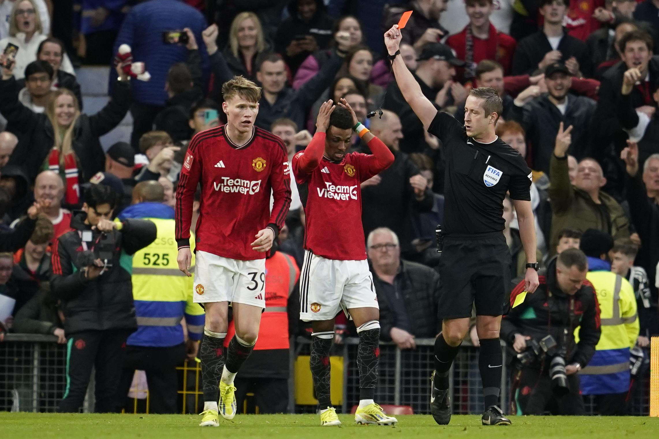 Amad Diallo is shown a red card after celebrating his winning goal against Liverpool