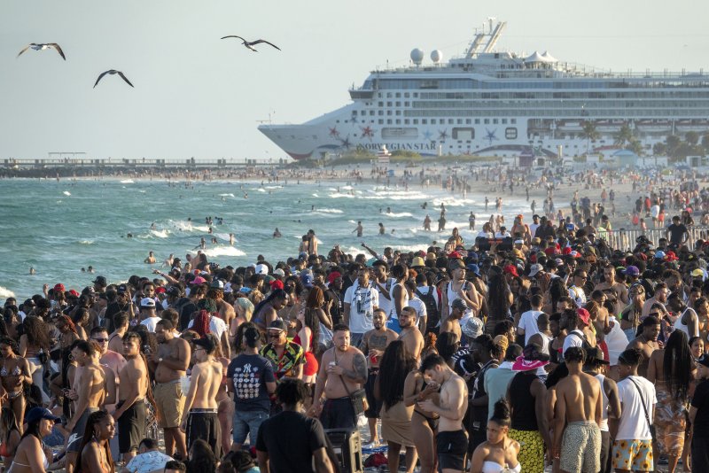 People spend time at the beach during spring break in Miami Beach in 2022. The city in a viral video announced it is "breaking up" with spring breakers and has imposed strict measures such as curfews, DUI checkpoints and restricted parking in an effort to cut down on chaotic activity. File Photo by Cristobal Herrerra-Ulashkevich/EPA-EFE