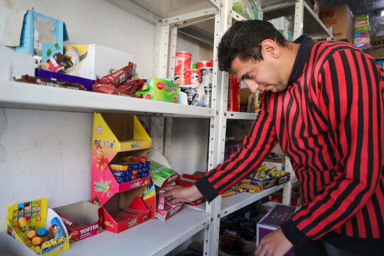 Osama stocks snacks on a shelf