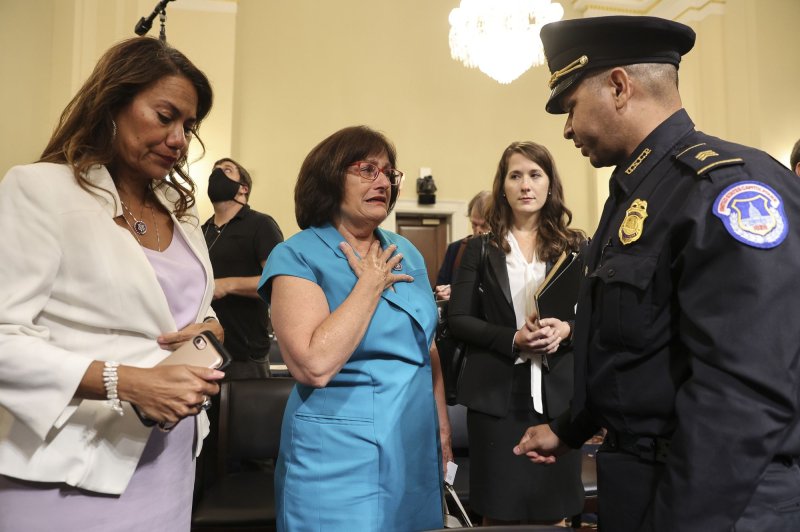 Rep. Ann McLane Kuster, D-N.H. (C), speaks to Sgt. Aquilino Gonell of the Capitol Police following a House Select Committee meeting investigating the Jan. 6, 2021, Capitol riot. She was joined by Rep. Veronica Escobar, D-Texas (L). On Wednesday, Kuster said she will not seek re-election. File Photo by Oliver Contreras/UPI